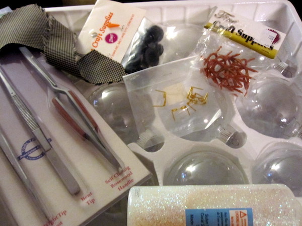tweezers and melted snowman ornament pieces