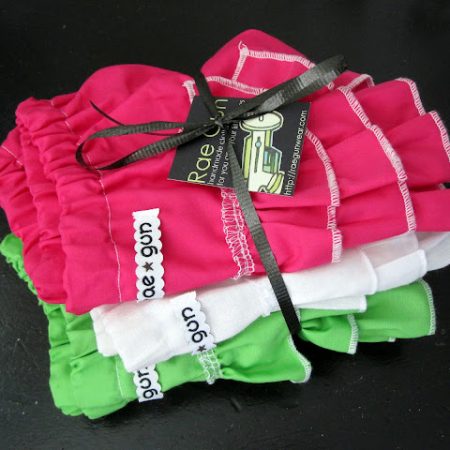 stack of Baby Ruffle Diaper Covers tied with a bow