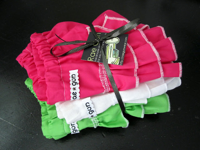 stack of Baby Ruffle Diaper Covers tied with a bow