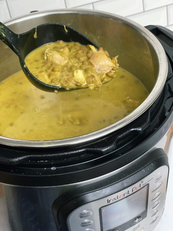 coconut curry lentil soup in ladle and Instant pot
