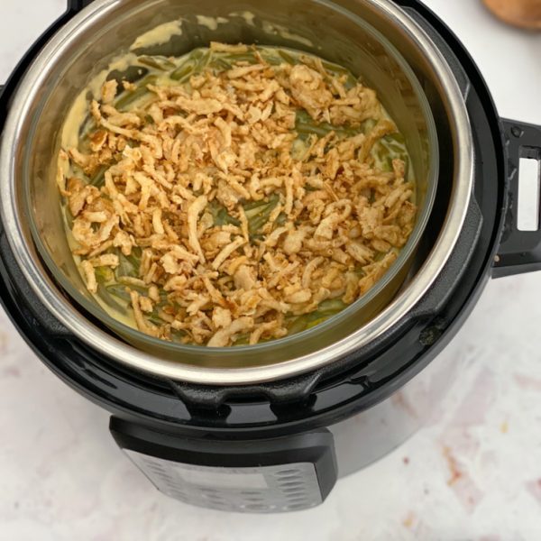 homemade green bean casserole topped with fried onions in an Instant pot