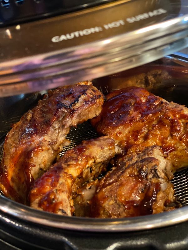 Ribs with BBQ sauce under crisping lid in Instant Pot pressure cooker