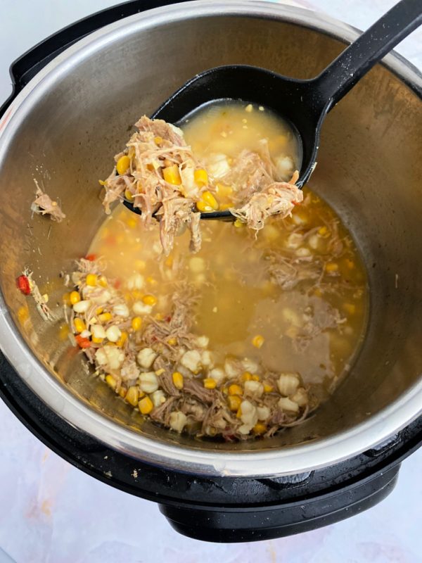 instant pot with ladle and pasole soup