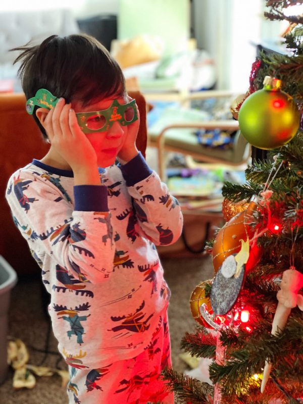 boy looking at christmas tree through 3d glasses