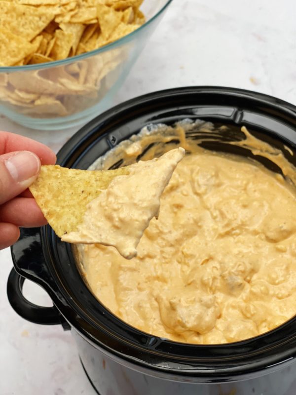 buffalo chick dip in small crock pot and chip