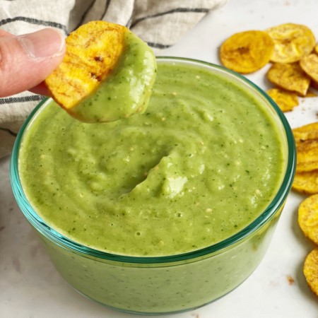 plantain chip dipped in avocado sauce