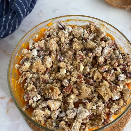 sweet potato casserole with pecan topping in class bowl