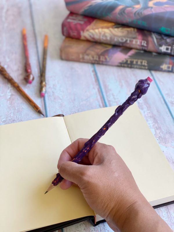 hand writing and using pencil wands