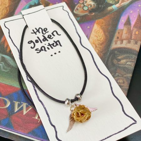 golden snitch necklace jewelry packaging card on Harry Potter book