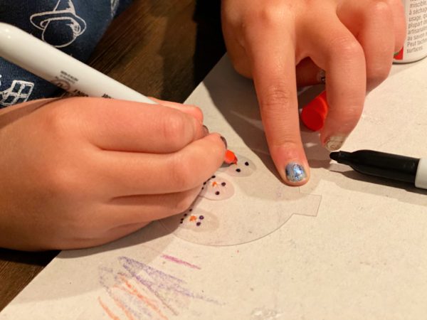 child drawing snowman faces