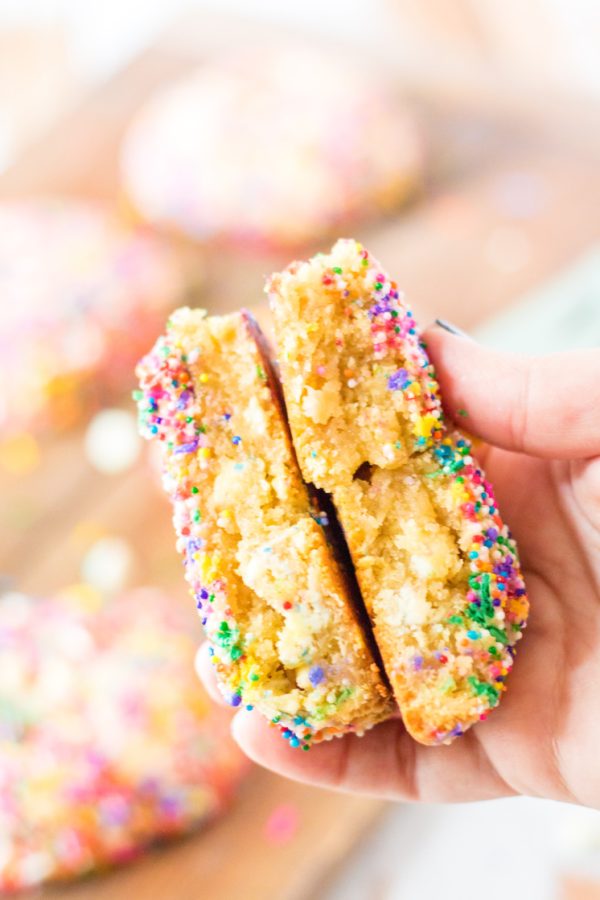 giant rainbow cookie folded in half in hand