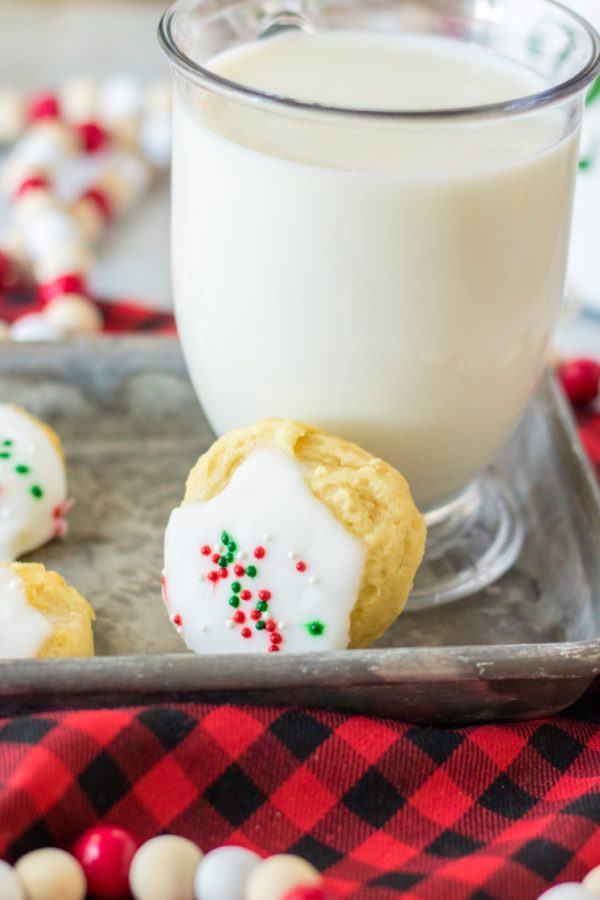 glass of milk with Christmas cookies on tray